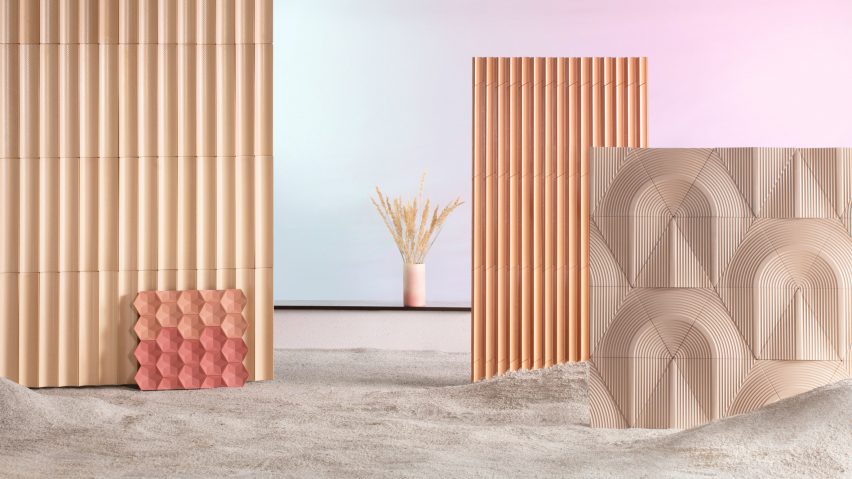Sculptural Earth Tone tiles by Cavaril on wall panels in a display with sand floor