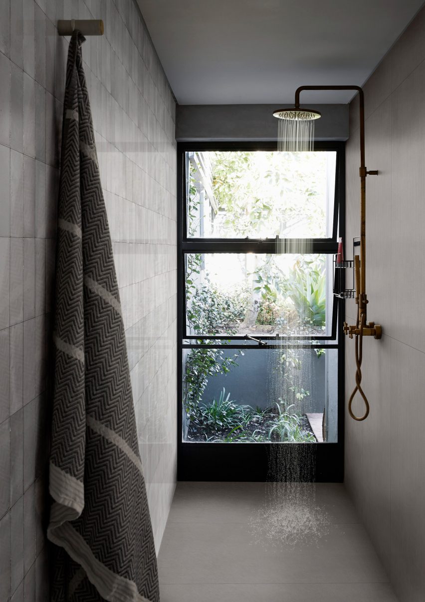 Photograph showing grey-floored wetroom with window