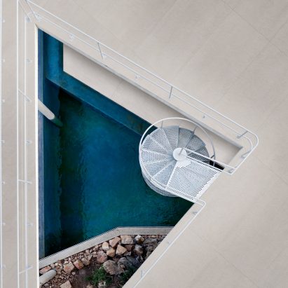 Aerial photograph of triangular hole in terrace floor with water beneath