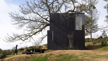 Person approaching Chestnut House in Portugal by João Mendes Ribeiro
