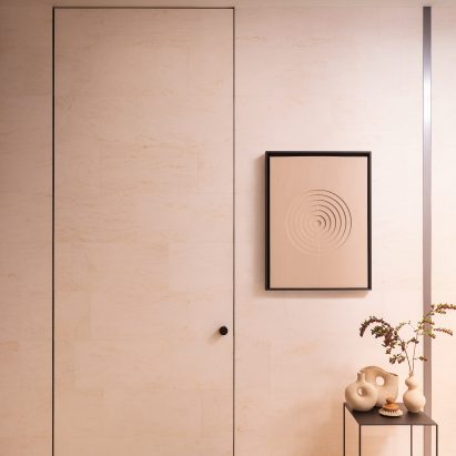 Photograph showing door in beige-pink toned wall