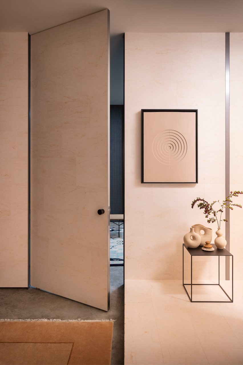 Photograph showing door in beige-pink toned wall