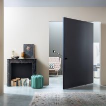Navy Compass 55 pivot door by Lualdi in a cream hallway
