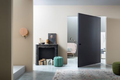 Navy Compass 55 pivot door by Lualdi in a cream hallway