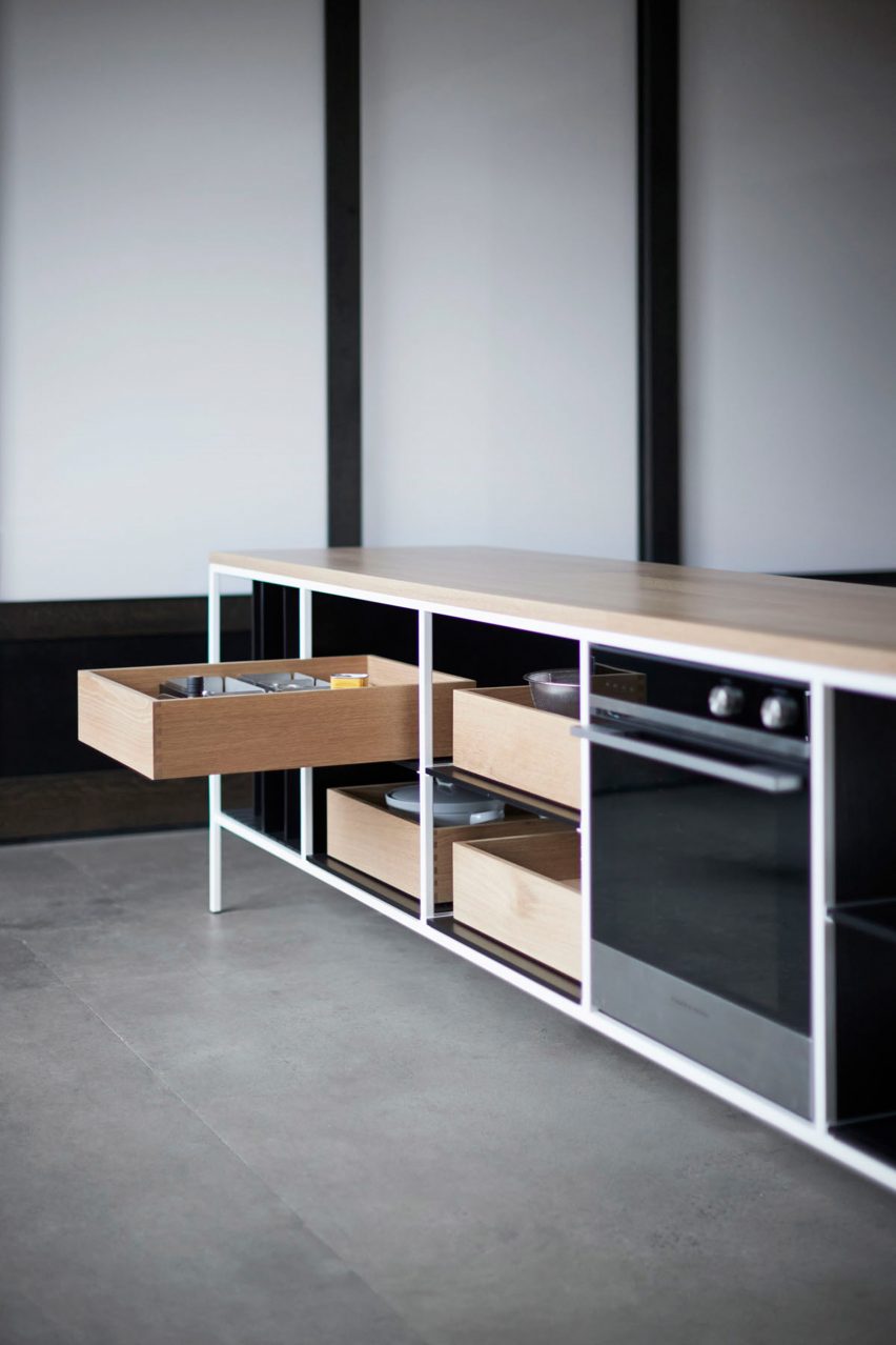 Kitchen island with open drawer in bright room