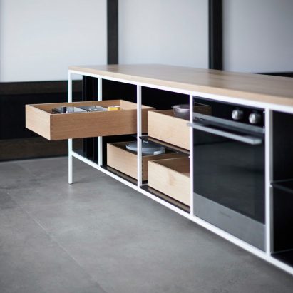 Kitchen island with open drawer in bright room
