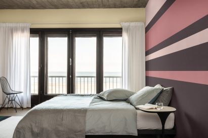 A bedroom interior with one golden wall
