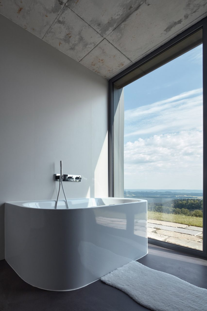 Photograph showing bath in room with large window