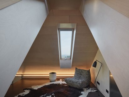 Photograph showing loft room with skylight and chair
