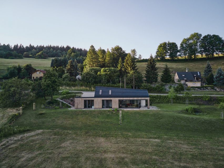 Photograph showing single-level gabled house looking over countryside