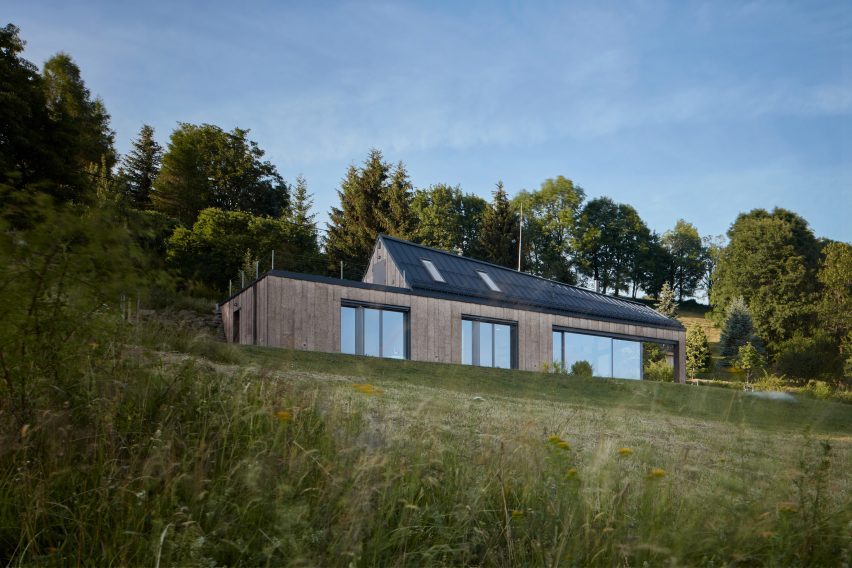 Photograph showing single-level gabled house looking over countryside