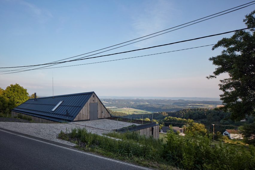 Photograph showing single-level gabled house looking over countryside