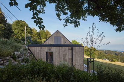 Photograph showing cork-clad end of house with front door