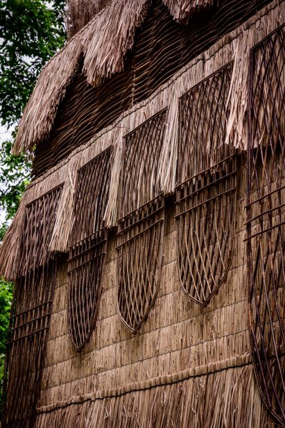 Pavilion walls made from woven hazel branches and reed