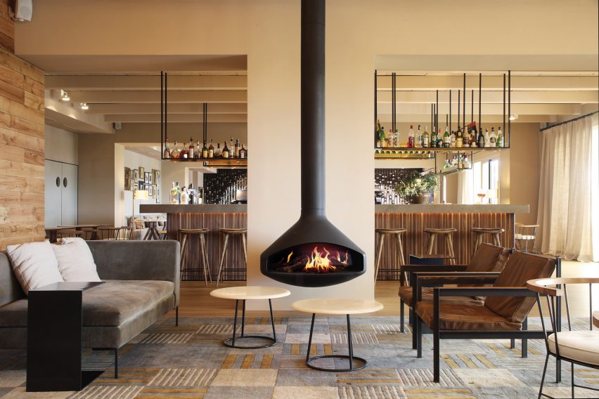 Freestanding fireplace by Focus with holographic fire in a cream living room