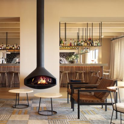Freestanding fireplace by Focus with holographic fire in a cream living room