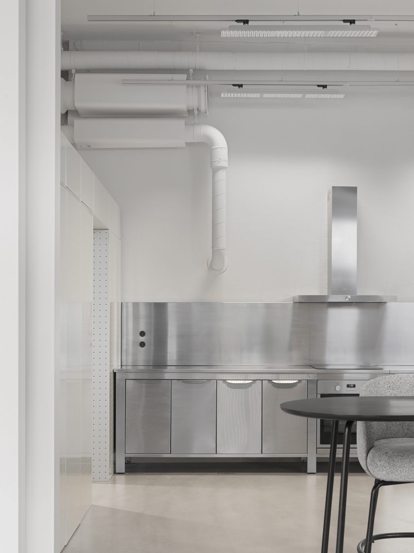 Steel kitchen and white perforated steel walls indesign studio
