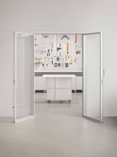 White wall with door that opens up to workshop by Form Us With Love