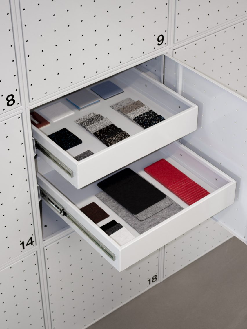 White drawers in a metal cupboard that contain material samples