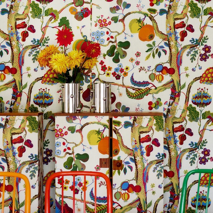 Wall with patterned fabric and pewter vases