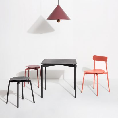 Orange Fromme chair by Petite Friture with the collection of stools and dining table
