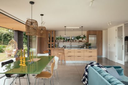 Bright kitchen in South Downs with green table and blue sofa
