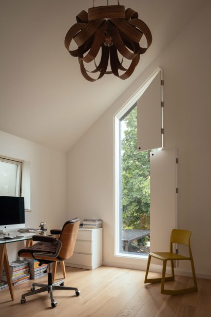 Bedroom with hanging light shade and folding internal blinds