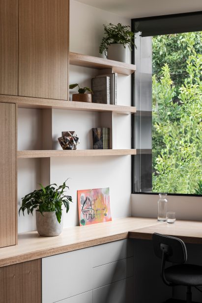 Minimalist home office with timber wall cabinets and desk