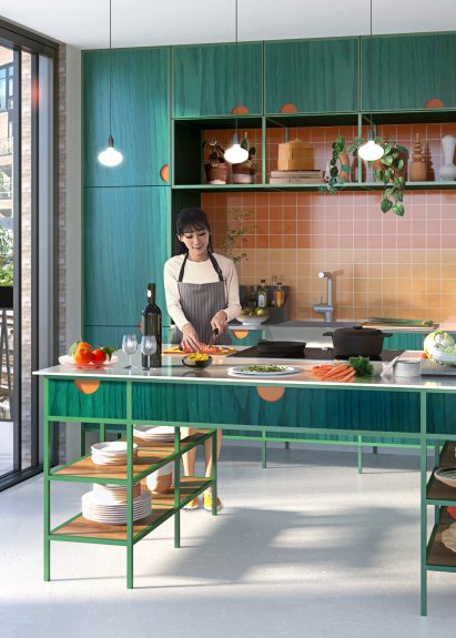 Woman cutting vegetables in contemporary green-coloured kitchen