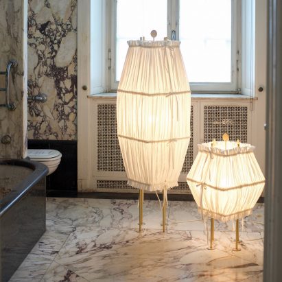 Two lights with hemp shades in a bathroom inside Lake Como Design Festival