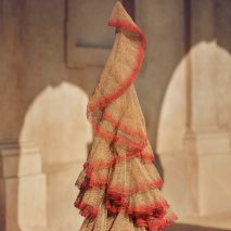 A beige and red fabric hanging