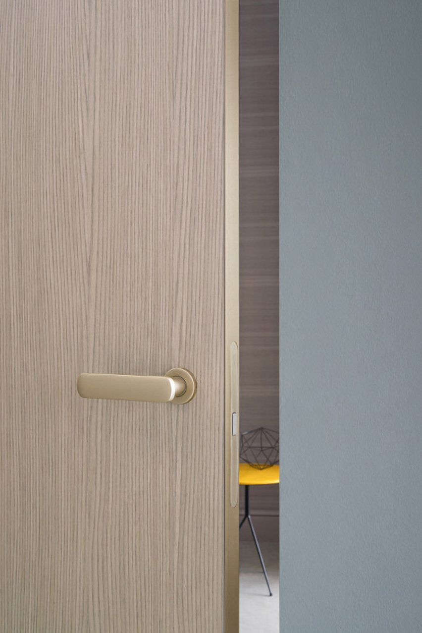 Close up of an oak door by Lualdi with brass edging and door handle