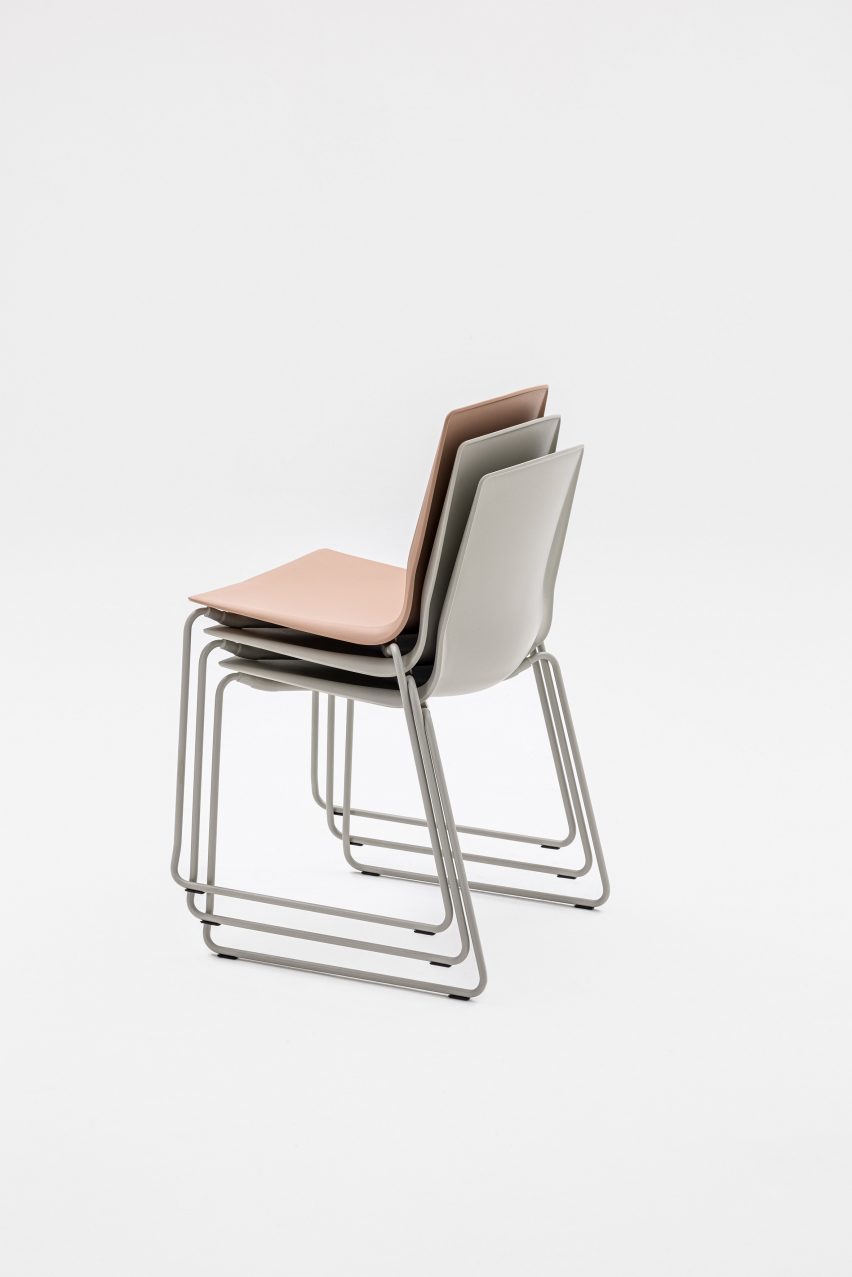 Photograph of pastel coloured chairs stacked