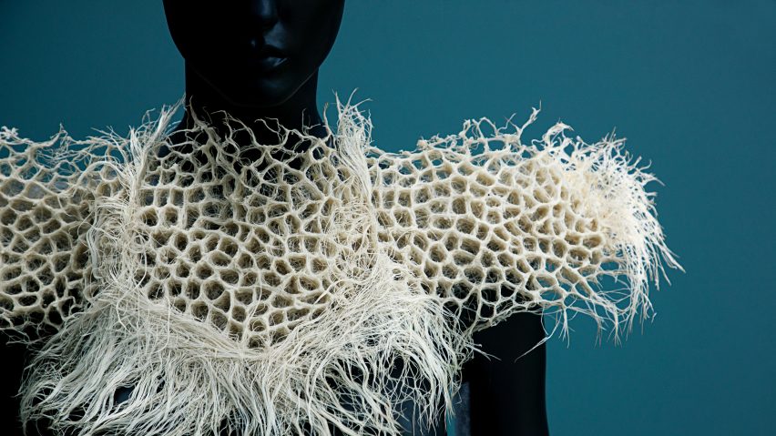 A mannequin wearing a white sculptural collar