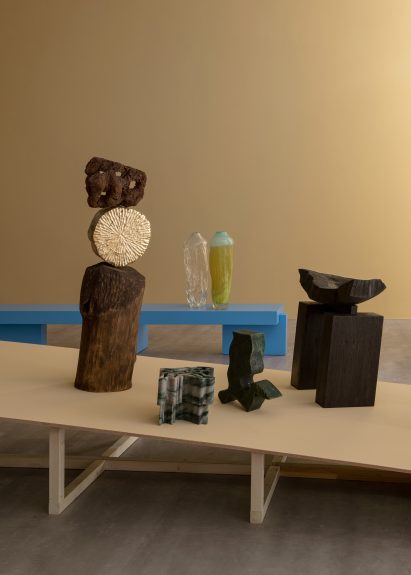 A blue bench and brown sculptures