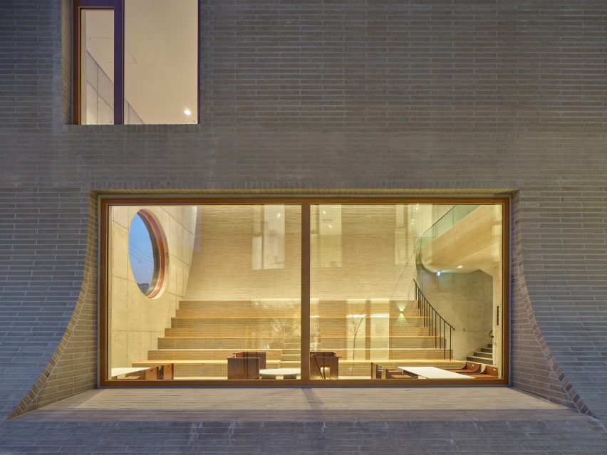 Large glazed window showing the interior of Cafe Teri with sloping back wall of the cafe