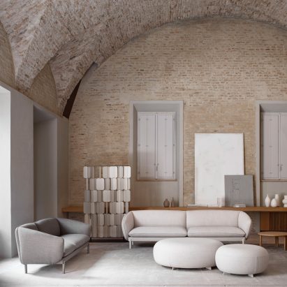 Two Not Sofas by True Design in a brick room with vaulted ceiling