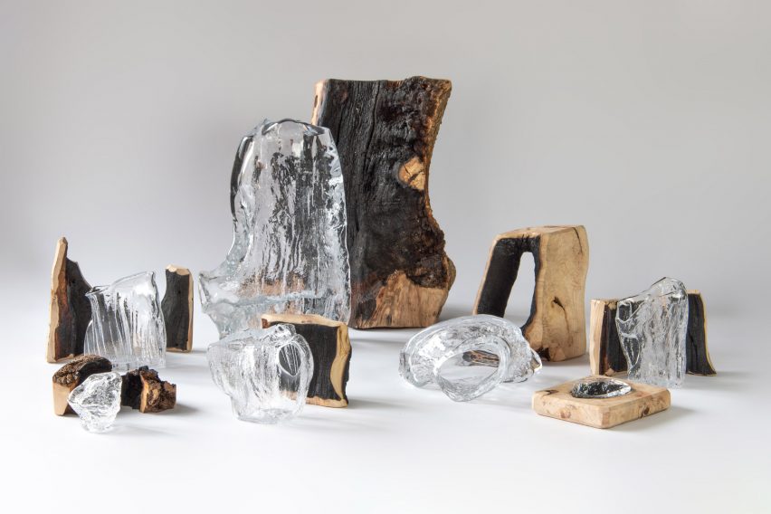 Photograph showing white backdrop with wood and glass objects