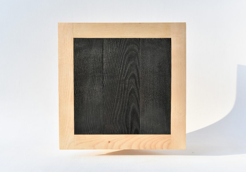 Photograph showing blackened wood square with ash wood frame surround