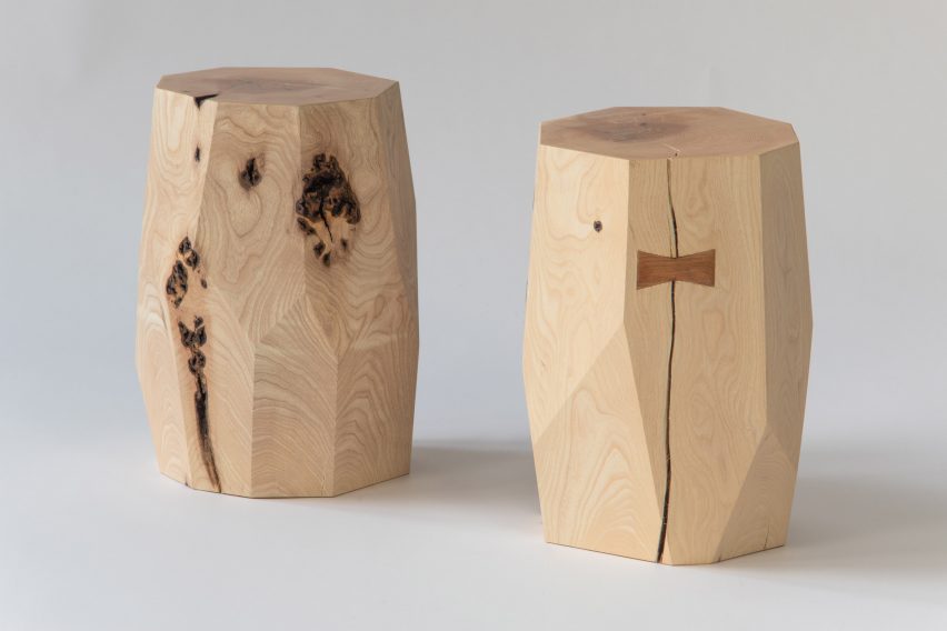 Photograph showing pair of wooden faceted stools/small tables on white backdrop