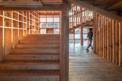 Timber staircase lined with bookshelves