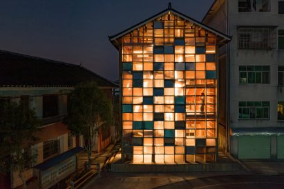 Pingtan Book House exterior with transparent and solid windows lit up at night