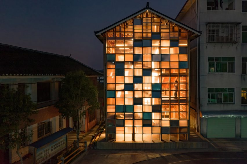 Pingtan Book House exterior with transparent and solid windows lit up at night