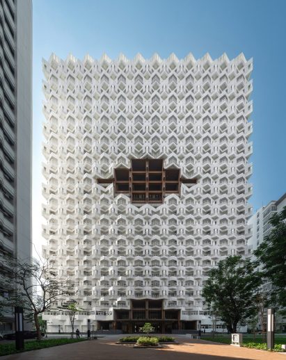 Balconies arranged in angular formation on facade of white apartment block by Plan Architect for nurses in Bangkok