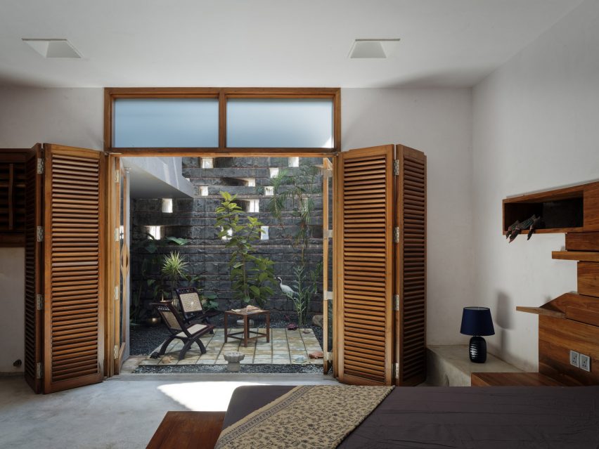 PMA madhushala wraps Indian home in perforated wall of brick and stone