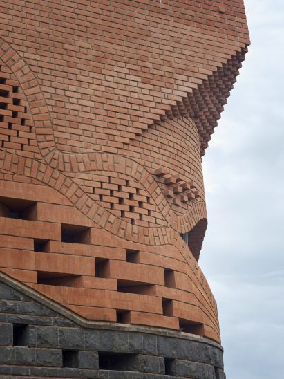 Exterior image of the waved brick facade at Gadi House