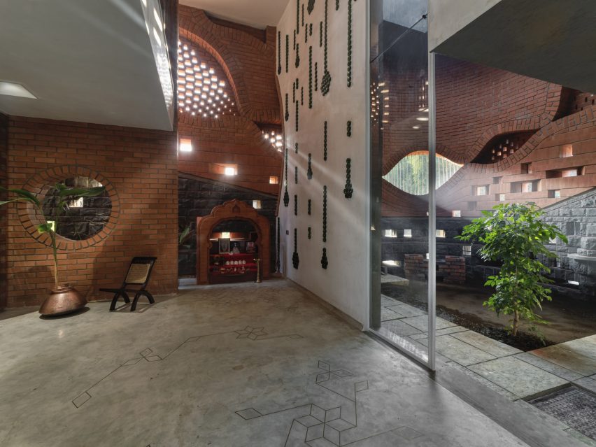 PMA madhushala wraps Indian home in perforated wall of brick and stone