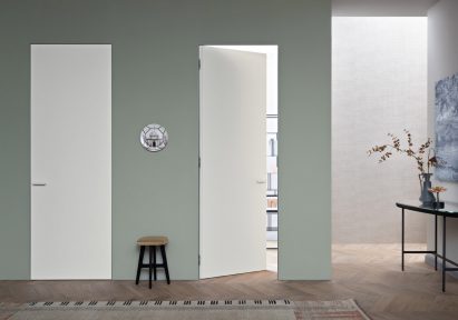 Two white Rasomuro 55s doors by Lualdi in a sage hallway