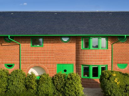 Green doors and windows of Red House by David Kohn Architects
