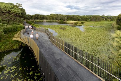 Aerial image of people crossing a pond